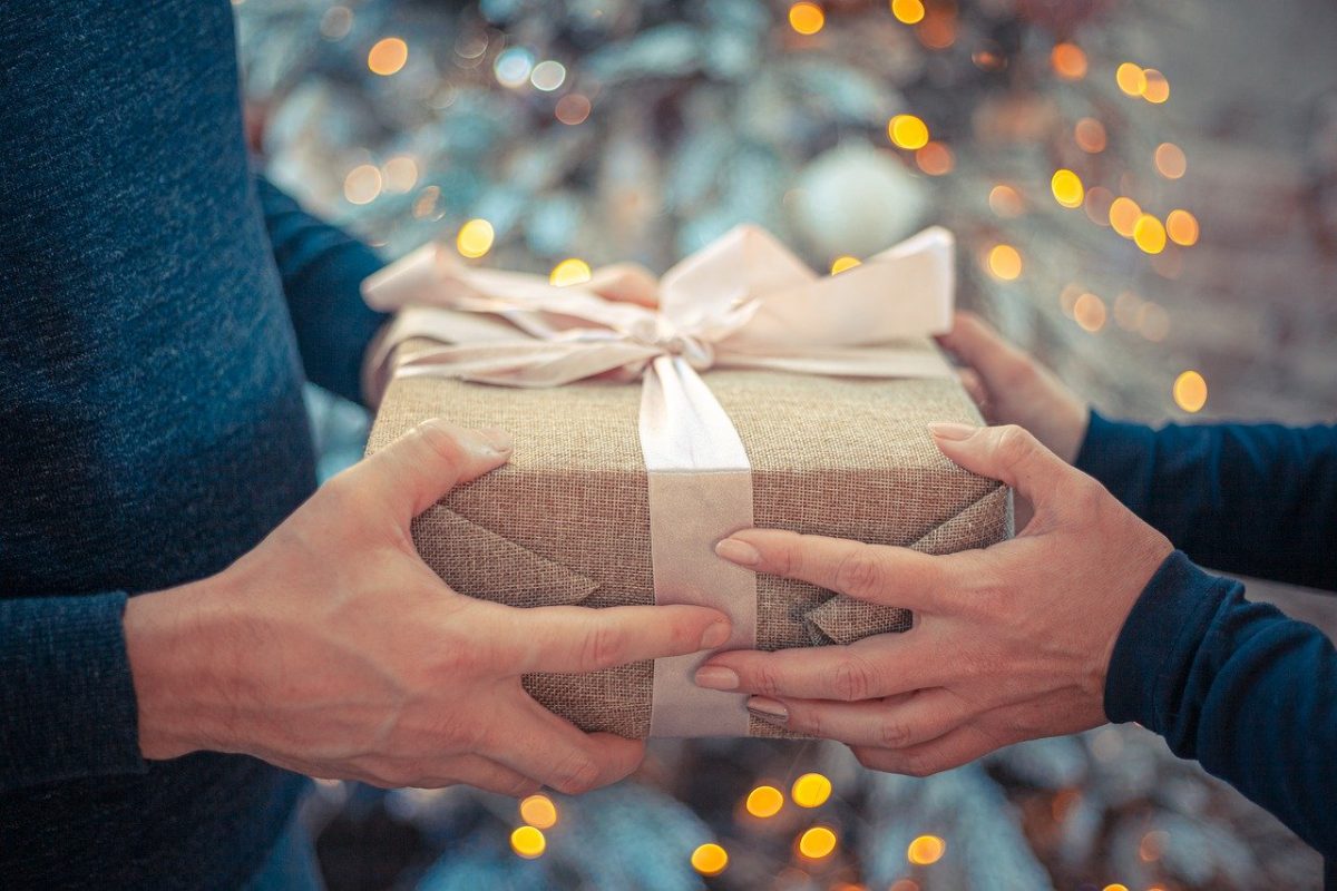 Hands giving and receiving gift