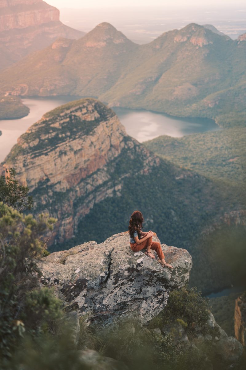 Woman sitting on a cliff