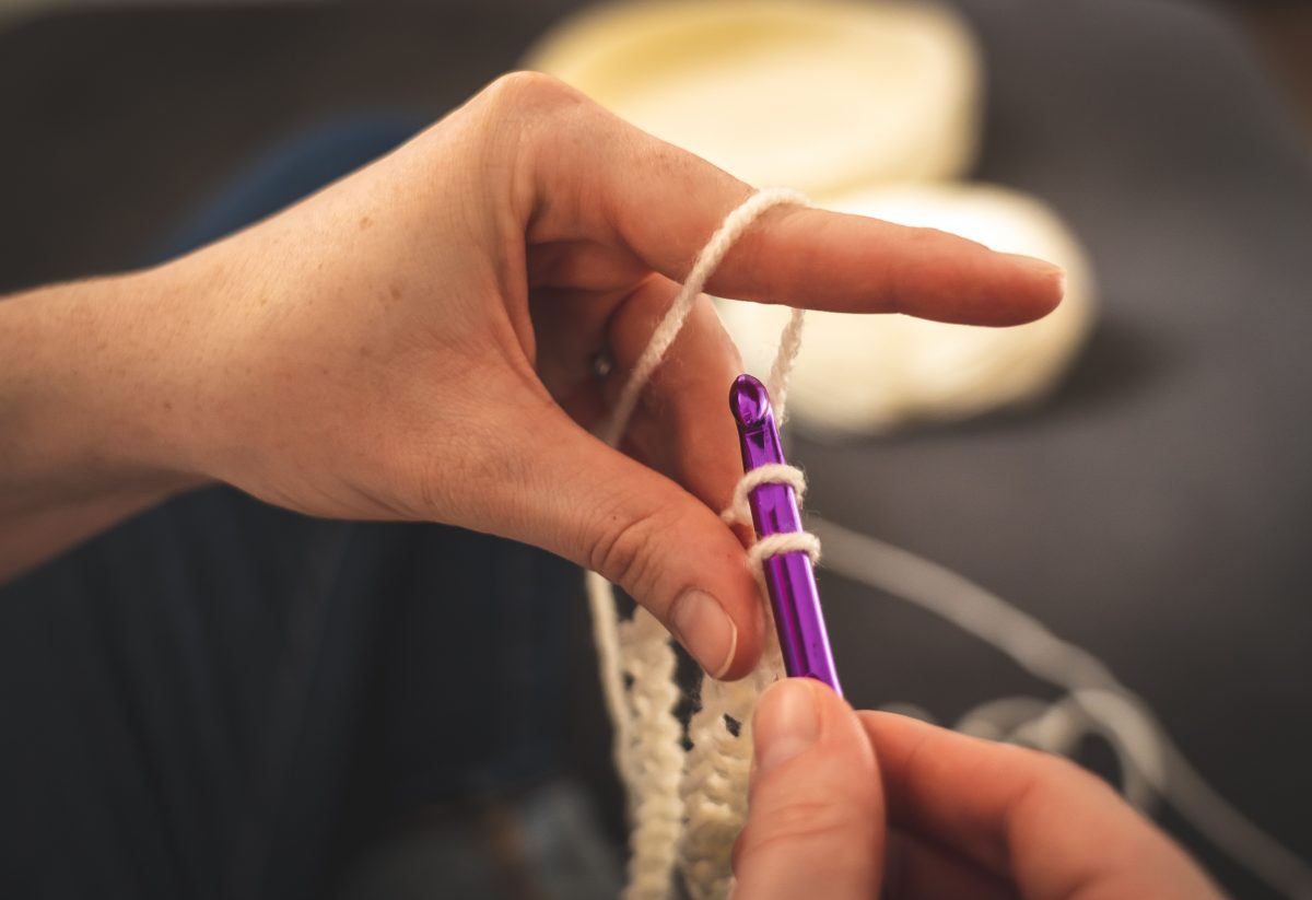 Person showing how to crochet