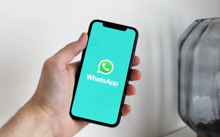 person holding iphone as they show whatsapp not working