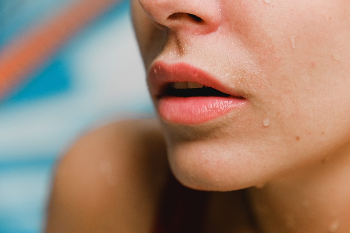 A close-up photo of a woman’s chin and lips.