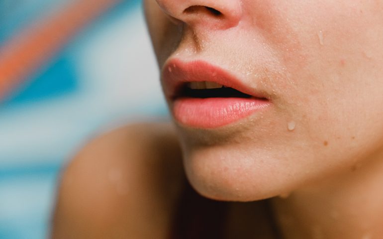 A close-up photo of a woman’s chin and lips.