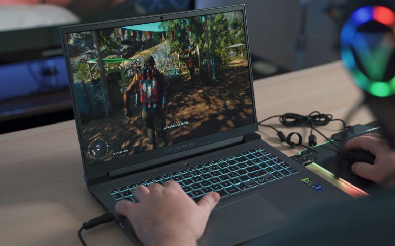 Man playing games on a laptop.