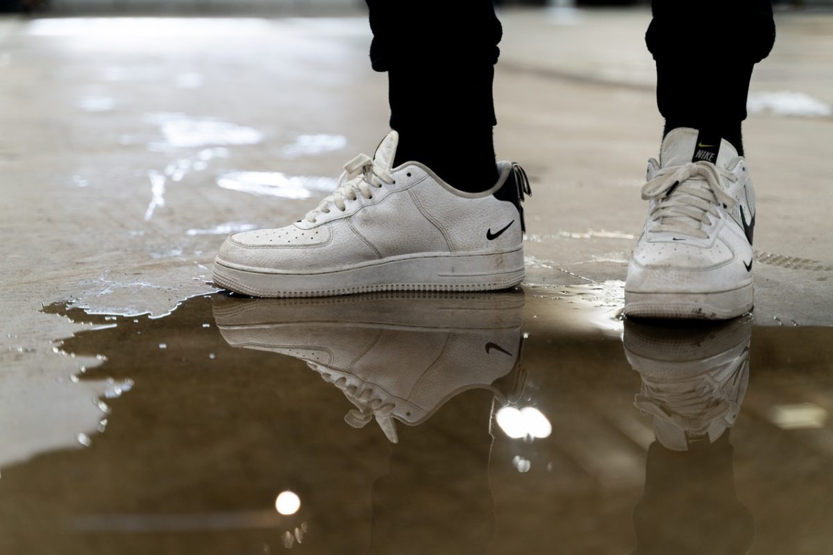 Person wearing white Air Force 1 sneakers.