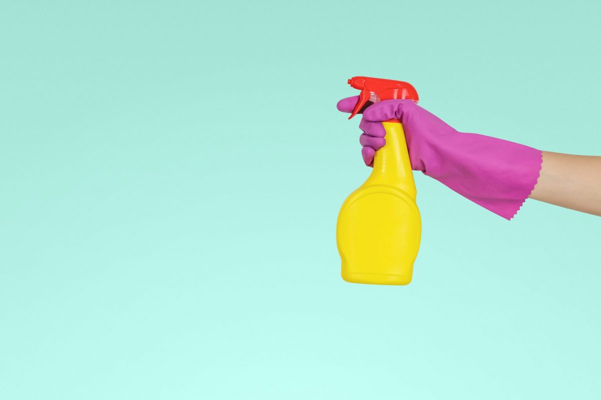 Person holding yellow spray bottle.