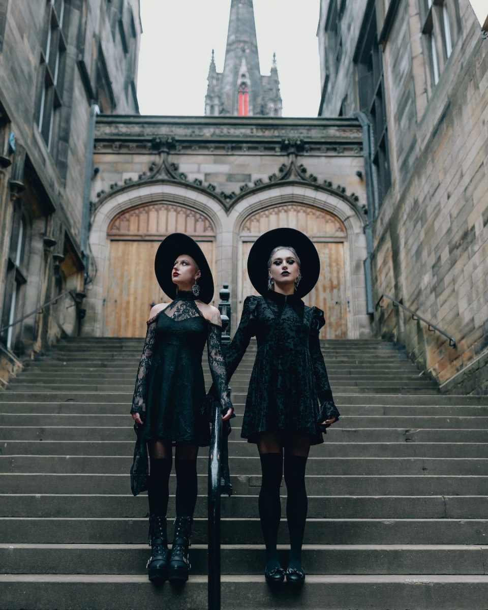 Two women posing in Gothic attire.