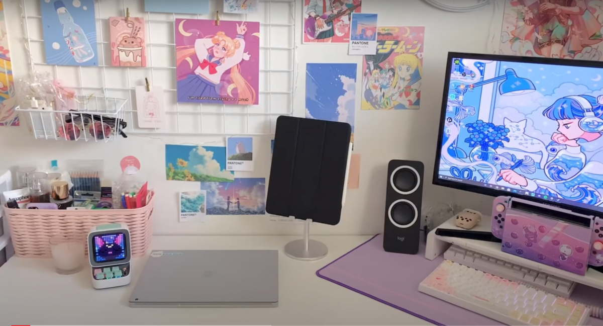 Pastel-themed gaming setup with anime decor.