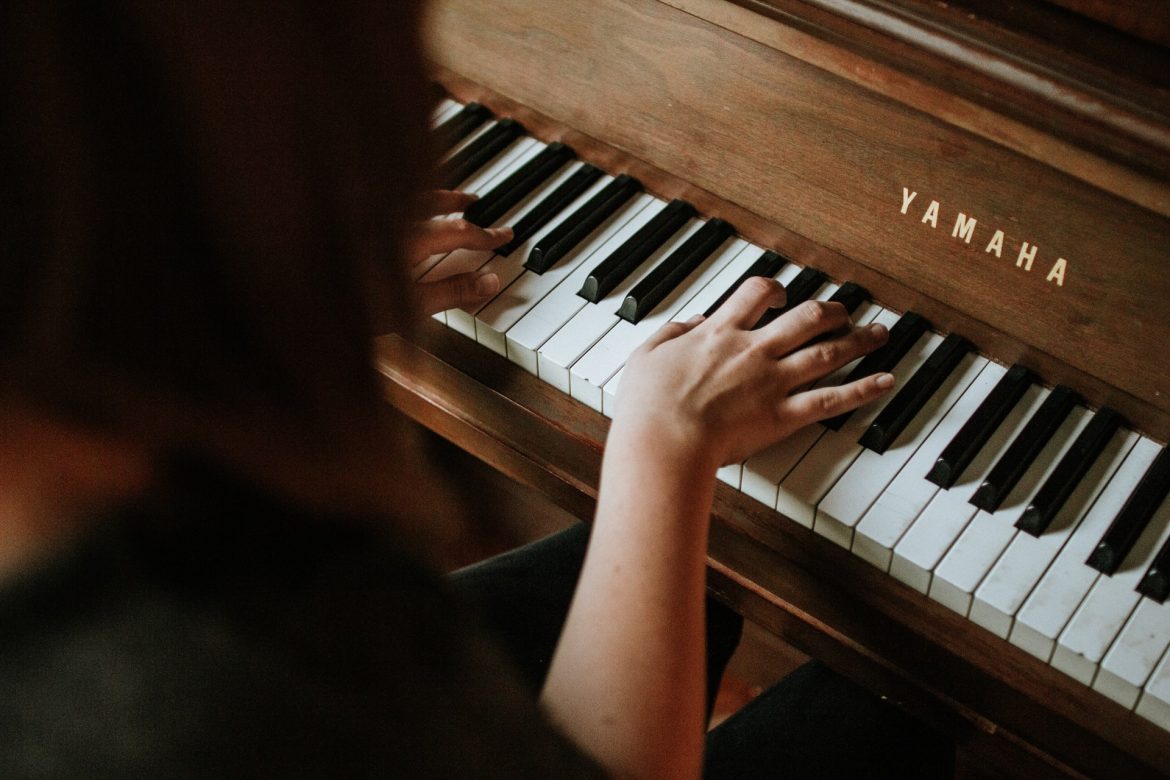 woman hands playing the piano