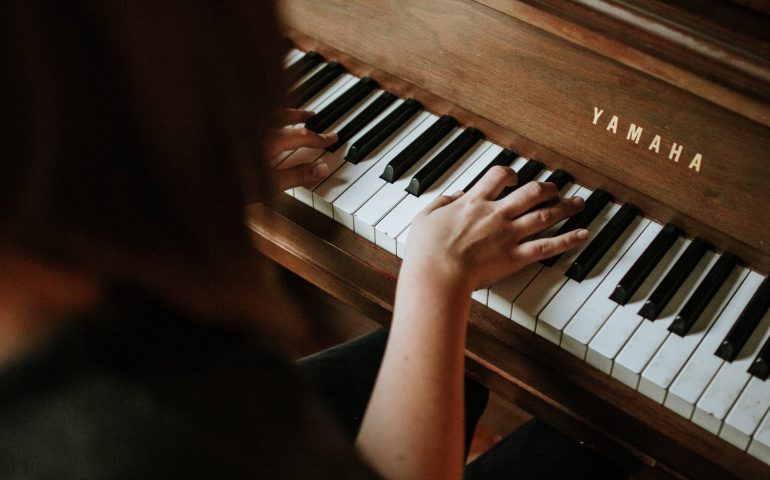 woman hands playing the piano