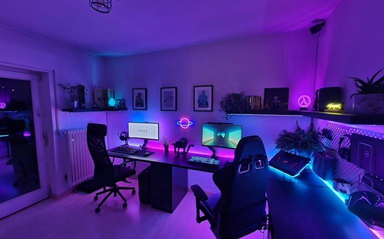 Couple gaming setup with purple lighting.