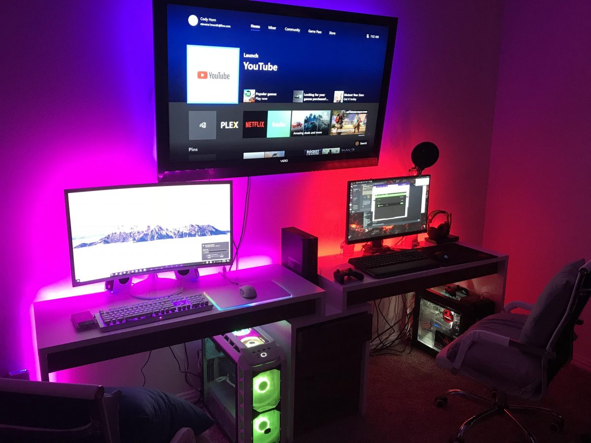 Gaming station for couples with a wall-mounted LED screen.