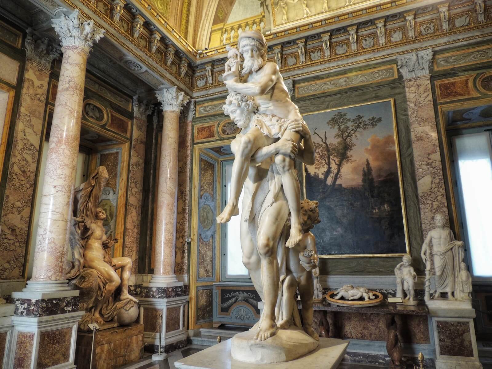 Who Is Aeneas Carrying On His Shoulders In Bernini’s Sculpture?