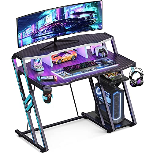 MOTPK Gaming Desk with LED Lights 39 Inch, Computer Desk with Monitor Storage Shelf, Gaming Table with Carbon Fiber Surface, Gamer Desk with Cup Holder & Headphone Hook, Gift for Boys Men, Black