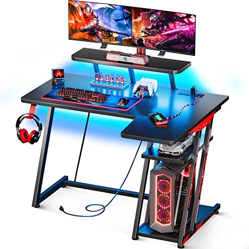 MOTPK L Shaped Gaming Desk with LED Lights, Small Corner Computer Desk 39inch with Power Outlets, Gaming Table with PC Storage Shelf, Gamer Desk with Monitor Shelf, Carbon Fiber Texture, Black